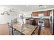 Kitchen with stainless steel appliances, dark wood cabinets, and a dining area at 9962 Derby Creek Way, Las Vegas, NV 89148