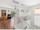Open-concept living space with hardwood floors and sliding glass doors to a balcony at 9962 Derby Creek Way, Las Vegas, NV 89148