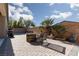 Spacious backyard with a brick-paved patio, outdoor seating, and desert landscaping at 1015 Solana Crest St, Henderson, NV 89052