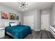 Cozy bedroom with wood floors, contemporary light fixture, and wall decor at 1015 Solana Crest St, Henderson, NV 89052