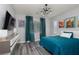 Bedroom featuring wood floors, contemporary light fixture, and natural light at 1015 Solana Crest St, Henderson, NV 89052