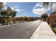 Gated community entrance featuring brick pillars, manicured landscaping, and secure access for residents at 1015 Solana Crest St, Henderson, NV 89052