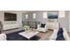 Bright living room featuring modern white furniture, a dark blue rug, and contemporary art at 1015 Solana Crest St, Henderson, NV 89052