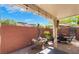 Charming outdoor patio area featuring a stone water fountain, dining set, and lush landscaping at 10370 Sweet Laurel St St, Las Vegas, NV 89178