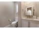 Cozy half bathroom with modern white vanity and framed mirror at 10370 Sweet Laurel St St, Las Vegas, NV 89178