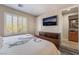 Comfortable bedroom featuring a TV, shutters on the windows, and a dark wood dresser at 10370 Sweet Laurel St St, Las Vegas, NV 89178