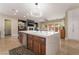 Modern kitchen island with a quartz countertop, stainless steel appliances, and stylish pendant lighting at 10370 Sweet Laurel St St, Las Vegas, NV 89178