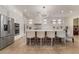 Modern kitchen featuring a center island, bar seating, and stainless steel appliances at 10370 Sweet Laurel St St, Las Vegas, NV 89178