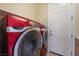 Modern laundry room with sleek, red appliances and ample space at 10370 Sweet Laurel St St, Las Vegas, NV 89178