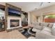 Inviting living room with a marble fireplace, built-in bar, and a comfortable white sectional sofa at 10370 Sweet Laurel St St, Las Vegas, NV 89178