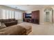 Cozy living room features a large sectional sofa, custom built-ins, and plantation shutters at 10370 Sweet Laurel St St, Las Vegas, NV 89178