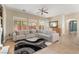 Bright living room boasts a large sectional sofa, expansive windows, and an open floor plan at 10370 Sweet Laurel St St, Las Vegas, NV 89178