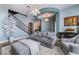 Comfortable living room featuring stylish decor, elegant lighting, and a staircase at 10370 Sweet Laurel St St, Las Vegas, NV 89178