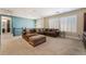Cozy living room features a large sectional sofa, custom built-ins, and plantation shutters at 10370 Sweet Laurel St St, Las Vegas, NV 89178