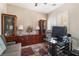 Well-lit home office with built-in cabinets, a glass desk, and comfortable seating at 10370 Sweet Laurel St St, Las Vegas, NV 89178