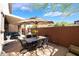 Spacious outdoor patio featuring a dining set and shade umbrella, perfect for entertaining at 10370 Sweet Laurel St St, Las Vegas, NV 89178