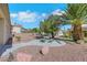 Desert landscaped backyard with a stone picnic table, palm tree, and mountain views at 10532 Sea Palms Ave, Las Vegas, NV 89134