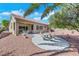 Backyard features a covered patio with an outdoor dining set and a quaint stone picnic table at 10532 Sea Palms Ave, Las Vegas, NV 89134