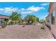 Large backyard features desert landscaping with patio, stone picnic table and mature trees at 10532 Sea Palms Ave, Las Vegas, NV 89134