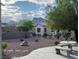 Well-maintained backyard featuring desert landscaping, trees, and a concrete picnic table at 10532 Sea Palms Ave, Las Vegas, NV 89134