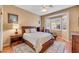 Comfortable bedroom features a ceiling fan, a window with shutters, and wood floors at 10532 Sea Palms Ave, Las Vegas, NV 89134