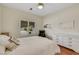Bright bedroom featuring white furniture, a plush bed with soft pillows and window with shutters at 10532 Sea Palms Ave, Las Vegas, NV 89134
