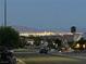 Scenic view of the Las Vegas city skyline at dusk from a residential street with lush trees and greenery at 10532 Sea Palms Ave, Las Vegas, NV 89134