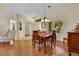 Well-lit dining room showcasing hardwood floors and elegant decor adjacent to other living spaces at 10532 Sea Palms Ave, Las Vegas, NV 89134