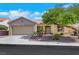 Inviting single-story home featuring a two-car garage, desert landscaping, and a welcoming front entrance at 10532 Sea Palms Ave, Las Vegas, NV 89134