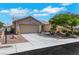 Attractive single-story home with a two-car garage, neat desert landscaping, and a paved driveway at 10532 Sea Palms Ave, Las Vegas, NV 89134