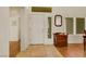 A bright foyer featuring tile and wood flooring, a white front door, and decorative accents at 10532 Sea Palms Ave, Las Vegas, NV 89134