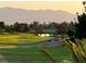 Beautiful golf course with mature trees, lush green fairways, and mountain views in a serene setting at 10532 Sea Palms Ave, Las Vegas, NV 89134