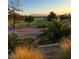 Picturesque view of the golf course with green fairways and sand traps at sunset; mountains in the distance at 10532 Sea Palms Ave, Las Vegas, NV 89134