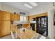 Well-lit kitchen with light-colored cabinetry, black appliances, and a breakfast table with seating for four at 10532 Sea Palms Ave, Las Vegas, NV 89134