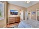 Comfortable main bedroom features a dresser, mounted TV, and plush bedding creating a relaxing retreat at 10532 Sea Palms Ave, Las Vegas, NV 89134