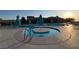 Community pool with chairs and umbrellas for relaxing and sunbathing at 10532 Sea Palms Ave, Las Vegas, NV 89134