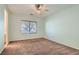 Bright bedroom featuring neutral walls, carpeted floors, and a ceiling fan at 10667 Casa Bianca St, Las Vegas, NV 89141