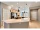 Kitchen featuring a large center island with a white countertop and stylish pendant lighting at 10667 Casa Bianca St, Las Vegas, NV 89141