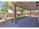 Backyard features a covered patio, artificial grass, and grill area at 11014 Great Sioux Rd, Las Vegas, NV 89179