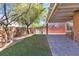 Backyard features artificial grass, grill area, and covered patio at 11014 Great Sioux Rd, Las Vegas, NV 89179