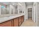 Bathroom with double sink vanity, large mirrors, and walk-in shower at 11014 Great Sioux Rd, Las Vegas, NV 89179