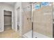 Modern bathroom with tiled shower featuring glass door and decorative window at 11014 Great Sioux Rd, Las Vegas, NV 89179