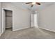 Bright bedroom featuring neutral carpet, ceiling fan, and doorways to other rooms at 11014 Great Sioux Rd, Las Vegas, NV 89179