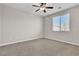 Neutral-toned bedroom featuring a ceiling fan and natural light at 11014 Great Sioux Rd, Las Vegas, NV 89179