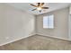 Bright, carpeted bedroom with neutral walls and a ceiling fan at 11014 Great Sioux Rd, Las Vegas, NV 89179