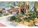 Charming two-story home with a well-maintained lawn, mature trees, and a 'for sale' sign at 11014 Great Sioux Rd, Las Vegas, NV 89179