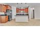 Kitchen featuring granite counters, stainless steel appliances, dark cabinetry, and modern hanging lights at 11014 Great Sioux Rd, Las Vegas, NV 89179