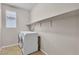 Laundry room featuring tile floors, large open shelf, and modern appliances at 11014 Great Sioux Rd, Las Vegas, NV 89179