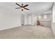 Upstairs living room featuring neutral carpet, ceiling fan, and stairwell at 11014 Great Sioux Rd, Las Vegas, NV 89179