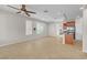 Bright living room featuring neutral walls, ceiling fan, tile flooring and kitchen view at 11014 Great Sioux Rd, Las Vegas, NV 89179